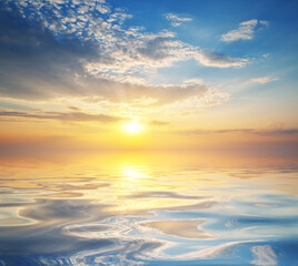 Wall Mural - nature background of colorful dramatic majestic sky clouds and sea waves during sunset.