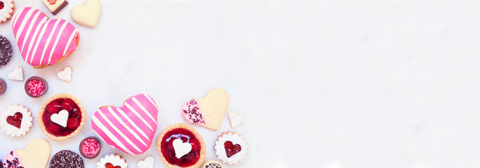 Aufkleber - Valentines Day baking corner border with a variety of cookies, chocolates and sweets. Top down view on a white marble banner background with copy space. Love and hearts theme.