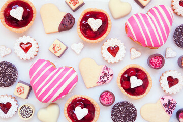 Aufkleber - Valentines Day baking background with a variety of cookies, chocolates and sweets. Overhead view on a white marble background with copy space. Love and hearts theme.