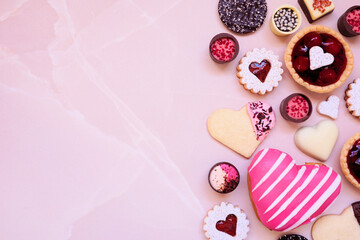 Aufkleber - Valentines Day baking and desserts side border with a variety of cookies, chocolates and sweet treats. Above view on a pink stone background with copy space. Love and hearts theme.