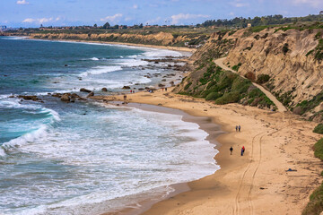 Sticker - A beach with a rocky cliff in the background