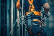 © Alexej - While working on a new construction site project, a construction worker uses a safety harness and safety line