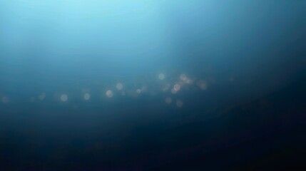abstract background featuring glittering lights in vibrant blue and gold shades, scattered against a dark black gradient.