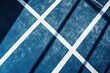 © Vladimir - A blue paddle tennis court with white lines, suitable for a horizontal sports poster, greeting cards, headers, and websites