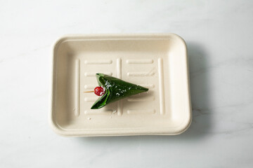 A top down view of an Indian betel leaf wrap dessert known as paan.