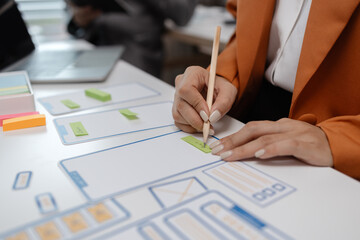 Wall Mural - ux developer and ui designer brainstorming about mobile app interface wireframe design in the office