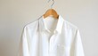 © Rama - A wooden hanger holding a crisp, white linen shirt against a simple background, symbolizing the elegance and sustainability of natural materials