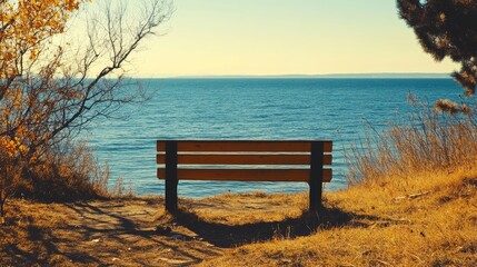 Aufkleber - Lone wooden bench overlooking a serene sea landscape on a sunny day with gentle waves and tranquil surroundings