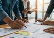 © NoelMatic - Business Team Analyzing Financial Documents in Meeting