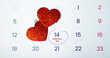© Anastasiia - A calendar with February 14th circled for Valentine's Day. Two glittery red hearts symbolize love, romance, and the celebration of this special occasion for couples.