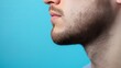 © พงศ์พล วันดี - Male Model Showcasing New Masculine Chin Shape Against Bright Blue Background