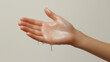 © Kanchanit - Dripping liquid on white-skinned girl’s hand, clean and fresh minimalist photography.