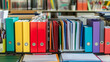 © PACHARA - A row of colorful binders on a table