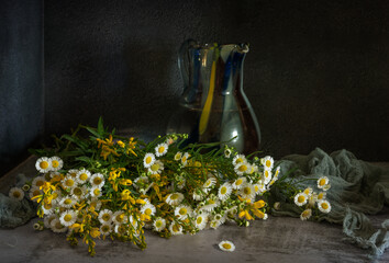 Wall Mural - Bouquet of meadow flowers on a dark background. Still life with meadow flowers.