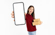 © sitthiphong - Smiling beautiful Asian woman holding cardboard boxes and hands show smartphone mockup of blank screen on white background. Take your screen to put on advertising. Concept delivery online.