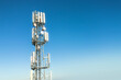 © AlexGo - Cellular tower against blue sky landscape