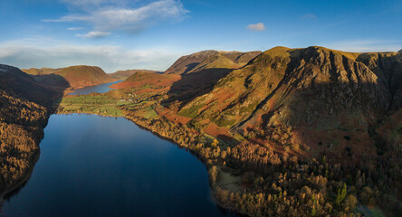 Wall Mural - Dramatic aerial drone landscape in Autumn Winter of snowcapped mountains around Buttermere in Lake District at sunrise