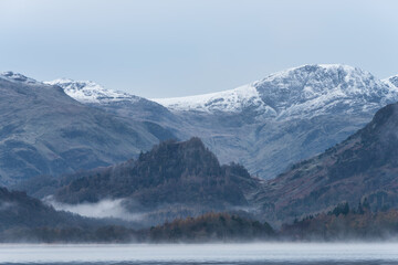 Wall Mural - Absolutely stunning dramatic atmospheric landscape image of Derwentwater during foggy sunrise in Autumn