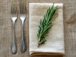 © Tasnim - Forks with Napkin and Rosemary on Burlap Background