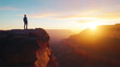 © PACHARA - A man stands on a cliff overlooking a canyon