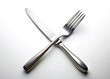 © Manatsavee - Crossed Knife and Fork, Elegant Cutlery on White, Isolated Background Stock Photo