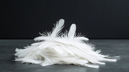 Sticker - Pile of white feathers on a grey surface. The feathers are scattered and piled up, creating a sense of chaos and disorder. The image evokes a feeling of emptiness and loneliness