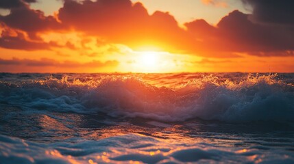 Poster - Stunning sunset over ocean waves creating a vibrant orange sky with dramatic clouds and tranquil seascape atmosphere