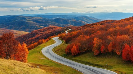 Poster - Winding mountain road through vibrant autumn foliage with scenic landscape and ample space for text placement on a clear day