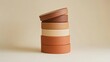 © alva studio - Stacked round containers in earth tones.