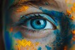 © AniMei - Close-up of a person's eye decorated with bright colored powders. The eye has a rich blue color