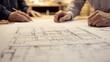 © Berkah1789 - Architects reviewing detailed building blueprints together