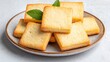 © Pojjanee - Freshly Baked Shortbread Cookies on a Rustic Plate with Green Leaves Decorating the Dessert