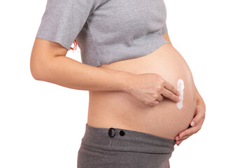 Pregnant woman applying cream to her belly for skincare and stretch mark prevention