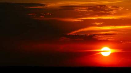 Wall Mural - dramatic red sunrise on dark cloudy sky
