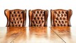 © Santri - Three empty brown leather tufted wingback chairs sit behind a large highly polished wooden table. Ideal for legal or corporate setting images.