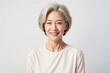 © KayKai - A woman with short gray hair is smiling at the camera