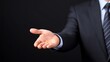 © Minom - A business professional extends a hand in a gesture of greeting or negotiation.