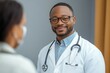 © SerPak - Doctor consulting with patient in medical office visit for health advice and care. Black History Month