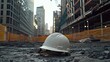 © Fathma - Hard hat rests on urban construction site, city backdrop