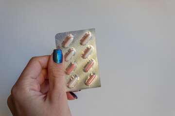 Woman hand holding pack of pills or blister with tablets. Concept of medicals, drug store, pharmacy, healthcare and medicine.