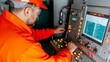 © A4719 - Industrial Worker Operating Complex Machinery Control Panel Safety Gear