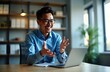 © Viktor - Asian businessman online meeting. Looks happy, gestures actively talking to colleagues on video call from office. Businessman uses laptop for virtual communication with team. Sharing plans ideas in