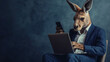 © Vasiliy - Kangaroo in business suit with laptop and phone. Business technology humor concept