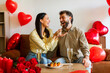 © Home-stock - Beautiful couple in love celebrating at home with romantic dinner, woman feeding her husband with sushi while celebrating Valentine's day