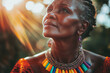 © Veronika - A middle-aged African woman staring in awe, with a rainbow necklace catching the light