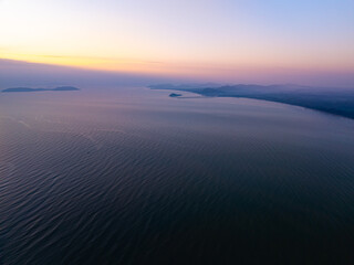 Wall Mural - Aerial view sunset sky,Nature beautiful light sunset or sunrise over sea,Colorful scenery sunset sky,Amazing clouds and waves texture, sunrise sky background