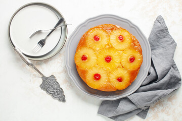 Wall Mural - Homemade pineapple upside down pie with candied cherries . Tropical dessert on white background. Top view