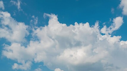 Wall Mural - blue sky with fluffy cloud time lapse on a sunny day 4k footage.