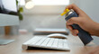 © Tati - Hand spraying air duster on keyboard in clean workspace