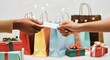 © Tati - Two people exchanging gift card amidst wrapped presents and colorful bags